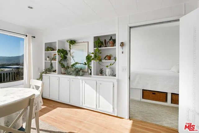 a bedroom with a bed and a potted plant