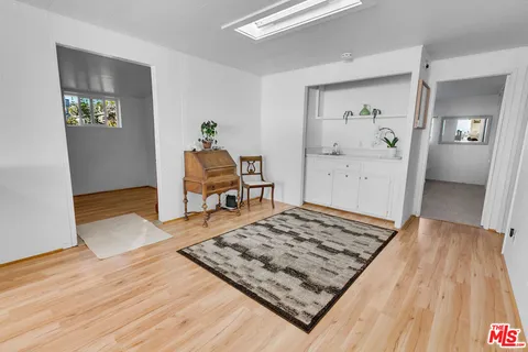 a bedroom with a bed window and a mirror