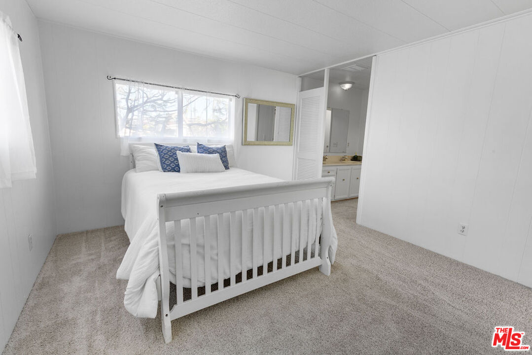 29500 Heathercliff Road, Unit 252 Malibu, CA 90265 - Photo 26 of 65 a bedroom with a bed and window