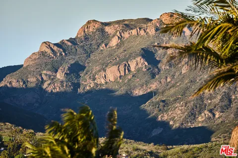 a white car parked in front of a house