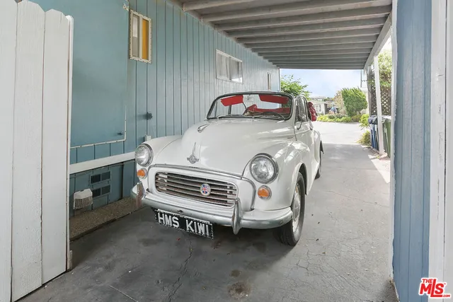 a kitchen with stainless steel appliances kitchen island granite countertop a stove and a wooden floors