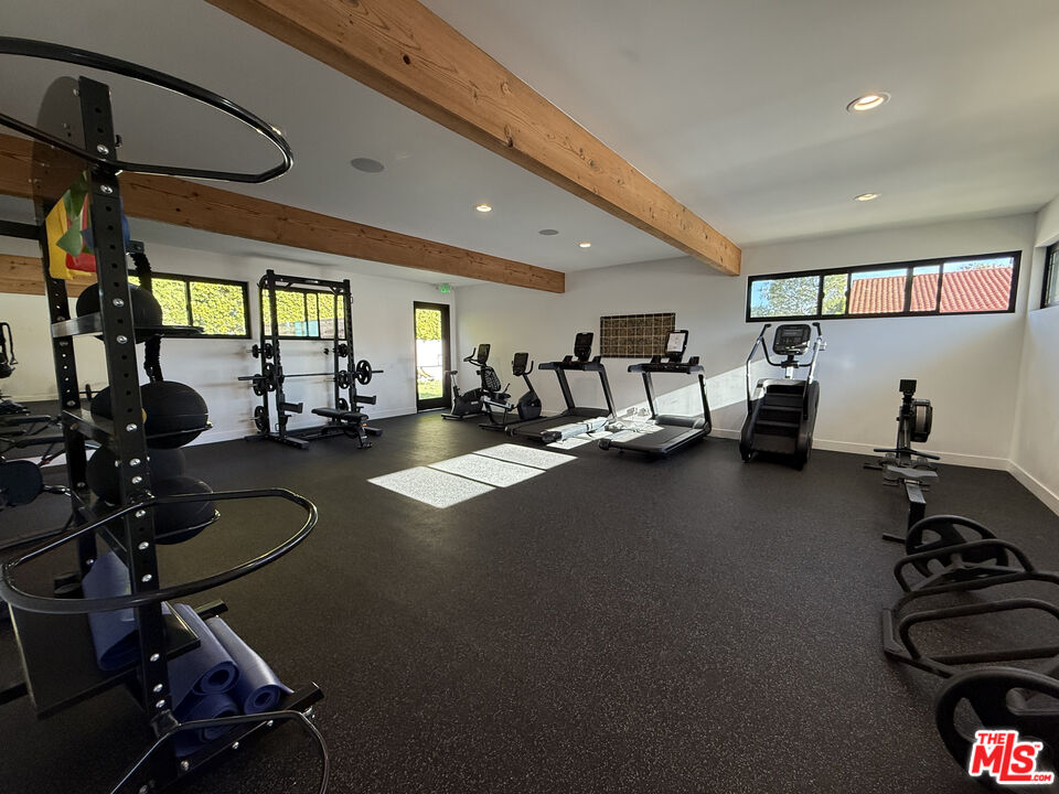 29500 Heathercliff Road, Unit 252 Malibu, CA 90265 - Photo 62 of 65 a room with gym equipment and a large window