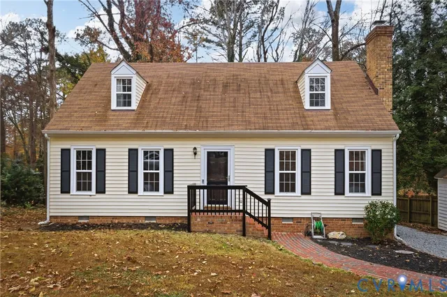 a house that has a tree in front of it