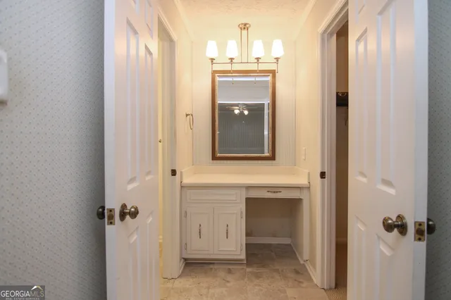 a bathroom with a sink and mirror with shower