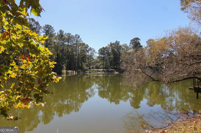 a view of a lake in between two and trees