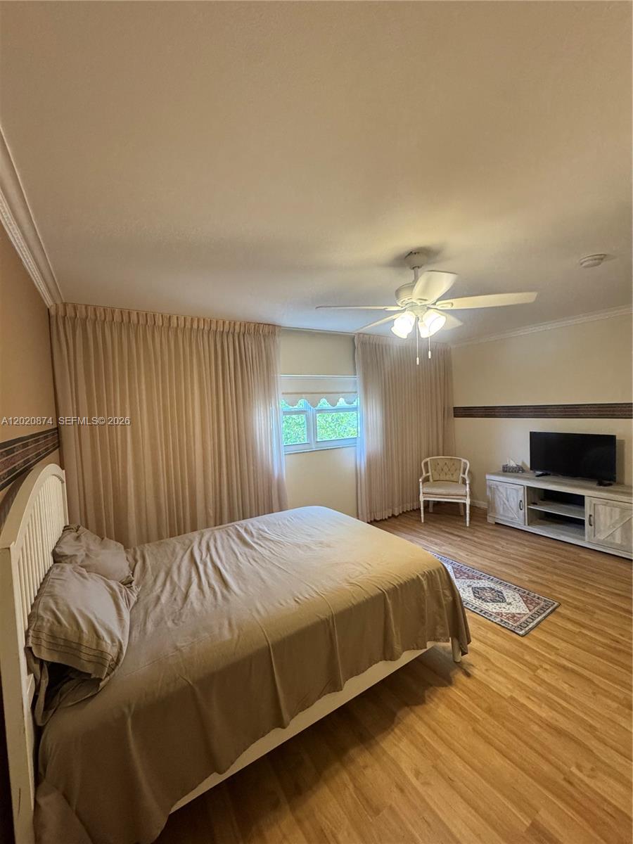 6731 Cypress Road, Unit 410 Plantation, FL 33317 - Photo 1 of 15 a bedroom with a bed and a television