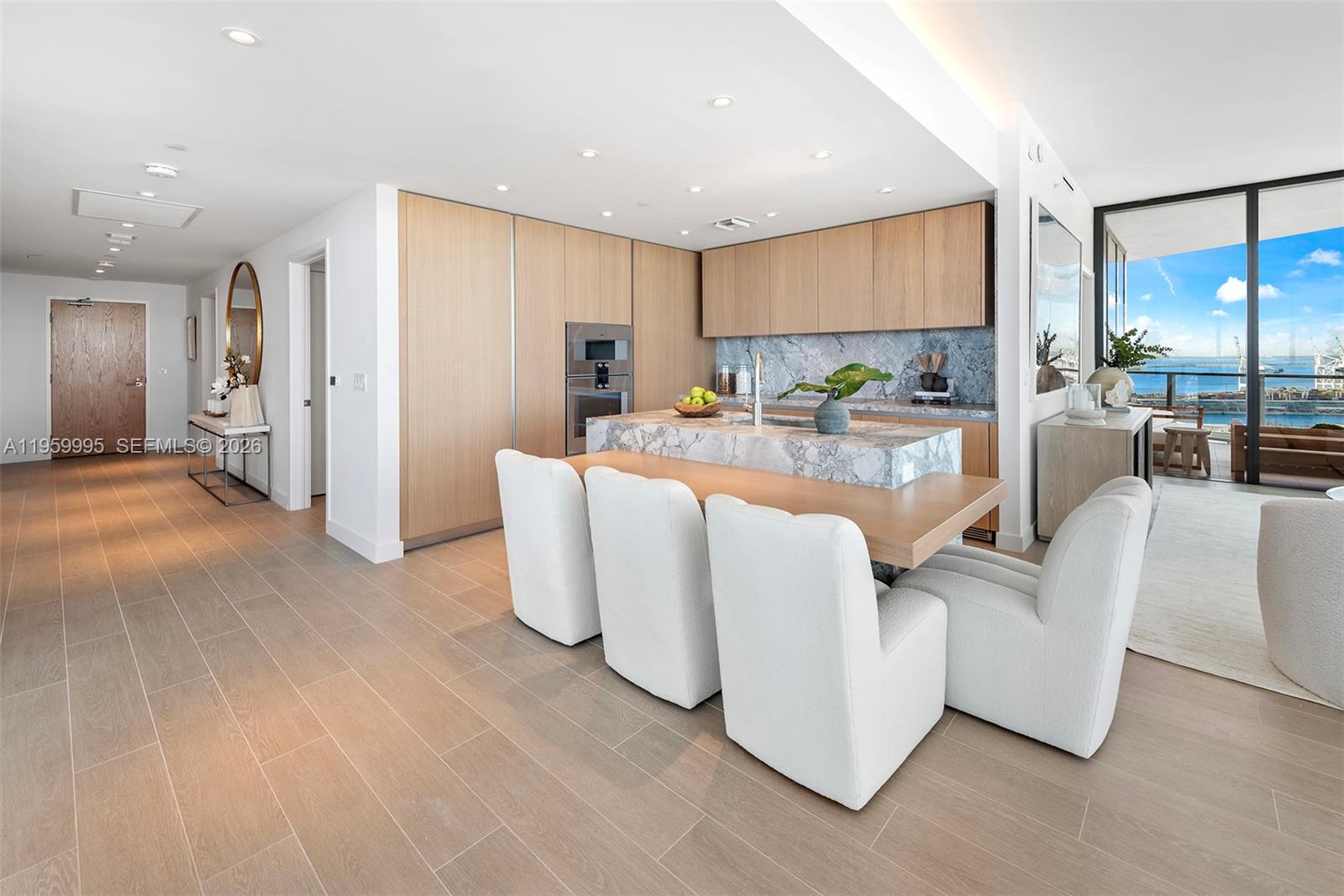 500 Alton Road, Unit 2903 Miami Beach, FL 33139 - Photo 18 of 52 a living room with furniture a large window with kitchen view