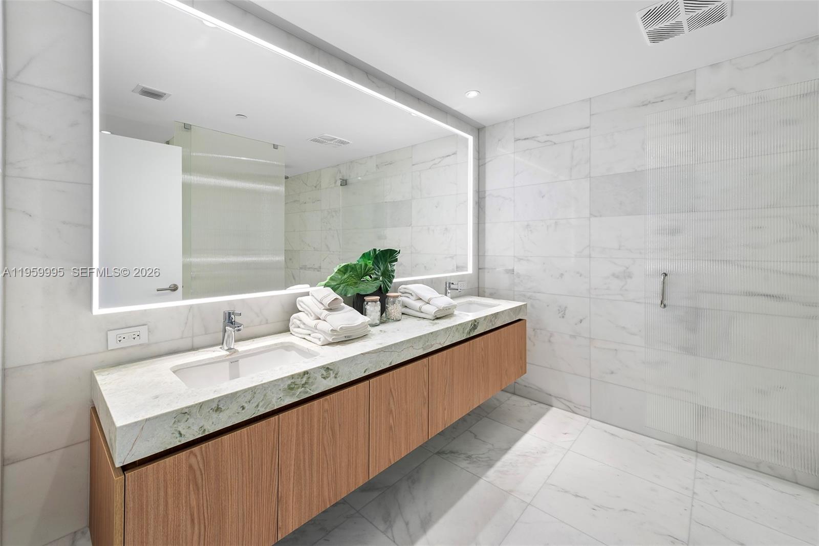 500 Alton Road, Unit 2903 Miami Beach, FL 33139 - Photo 28 of 52 a bathroom with a granite countertop sink a large mirror and shower