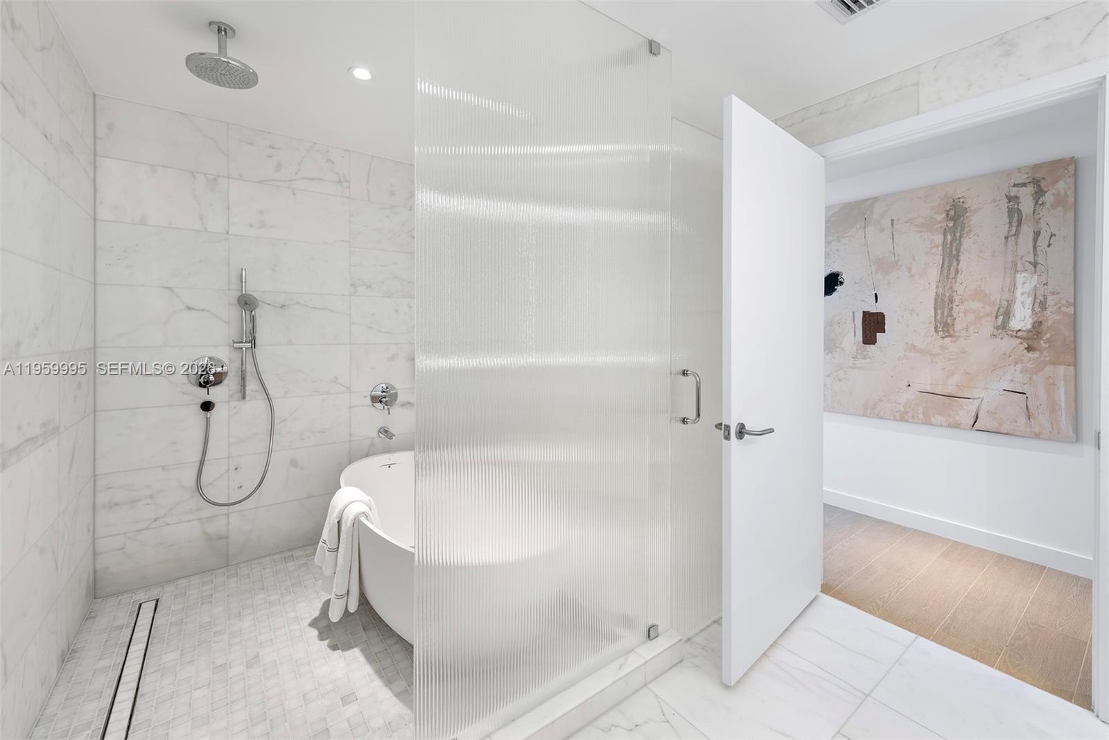 500 Alton Road, Unit 2903 Miami Beach, FL 33139 - Photo 29 of 52 a bathroom with a white bath tub sitting next to shower