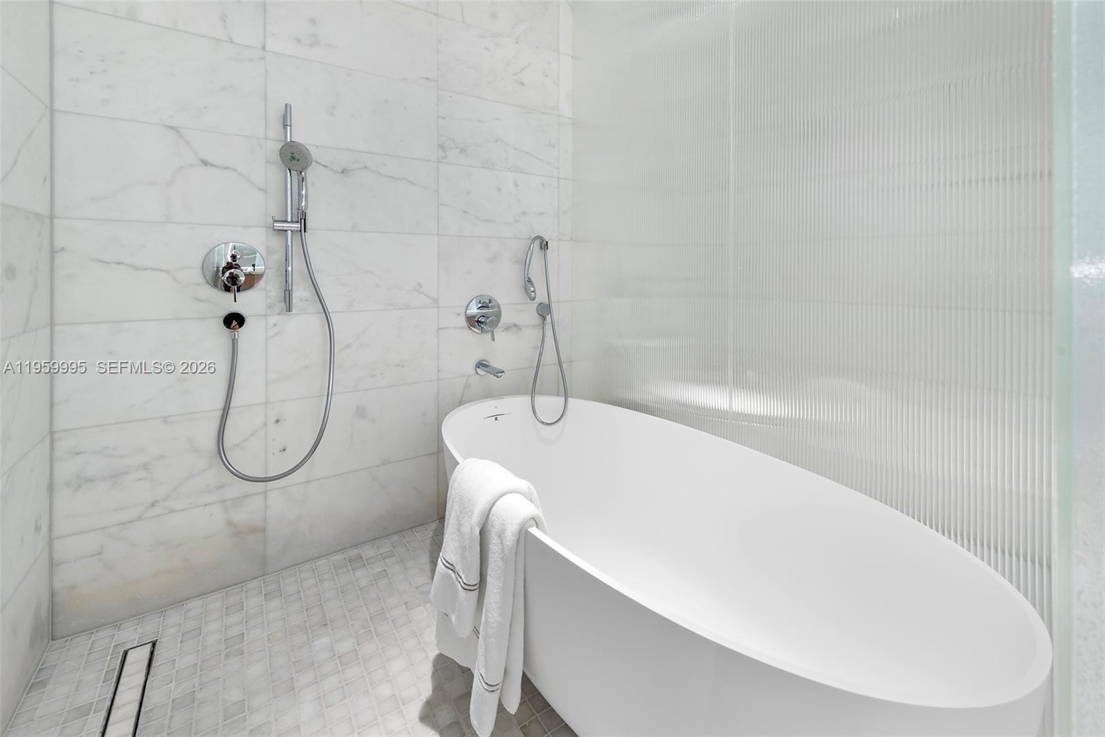 500 Alton Road, Unit 2903 Miami Beach, FL 33139 - Photo 30 of 52 a bathroom with a bath tub with a shower