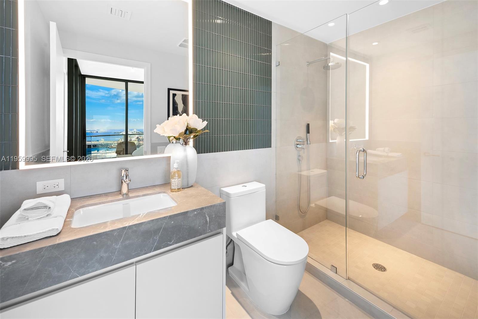 500 Alton Road, Unit 2903 Miami Beach, FL 33139 - Photo 37 of 52 a bathroom with a sink a toilet and shower