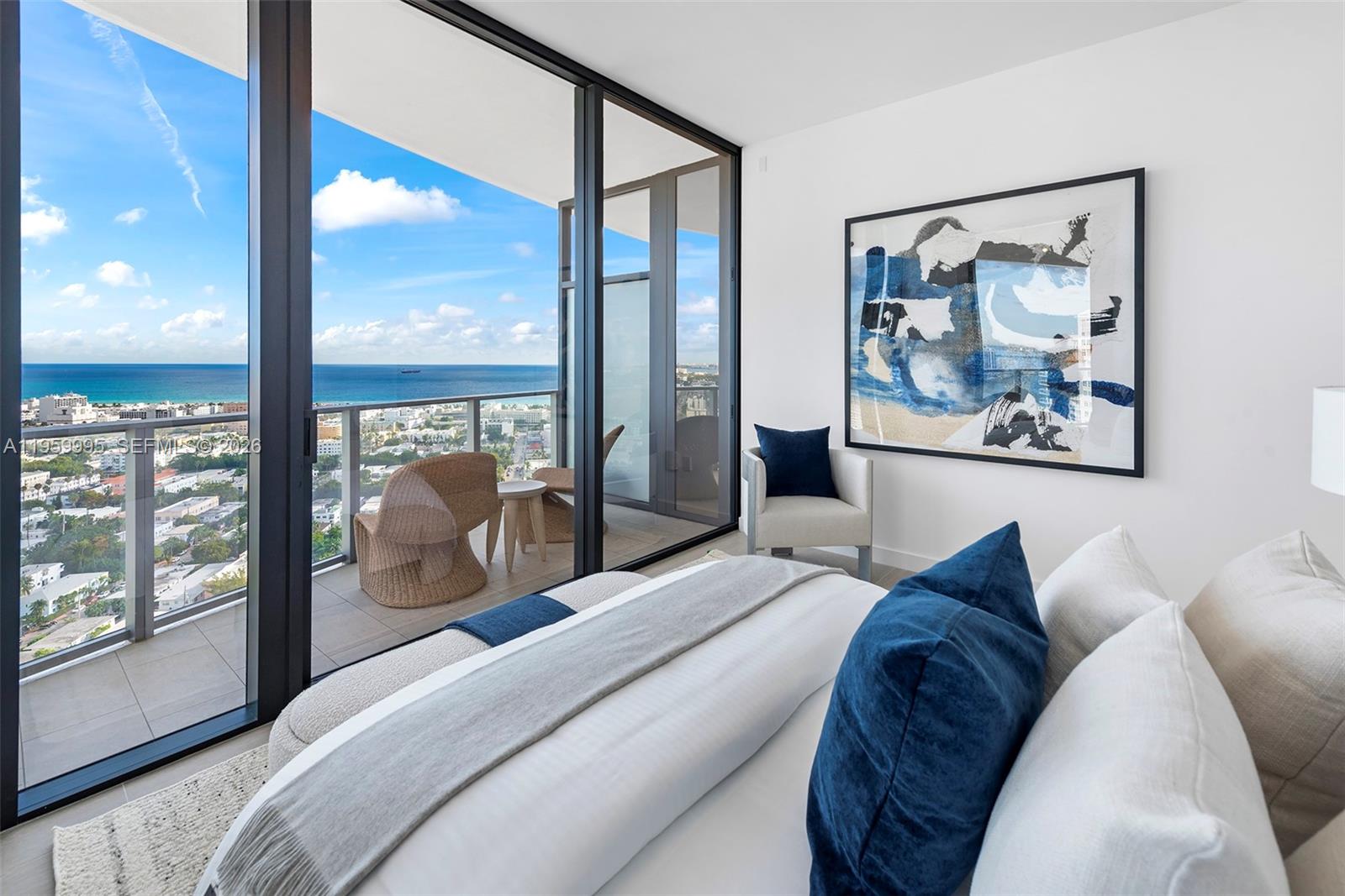 500 Alton Road, Unit 2903 Miami Beach, FL 33139 - Photo 39 of 52 a bedroom with a large bed and a painting on the wall