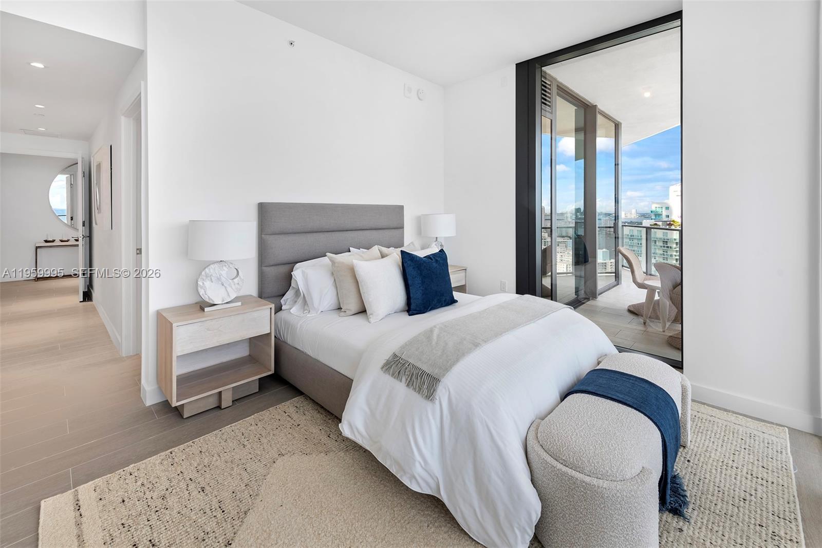 500 Alton Road, Unit 2903 Miami Beach, FL 33139 - Photo 40 of 52 a bedroom with a large bed and a balcony view