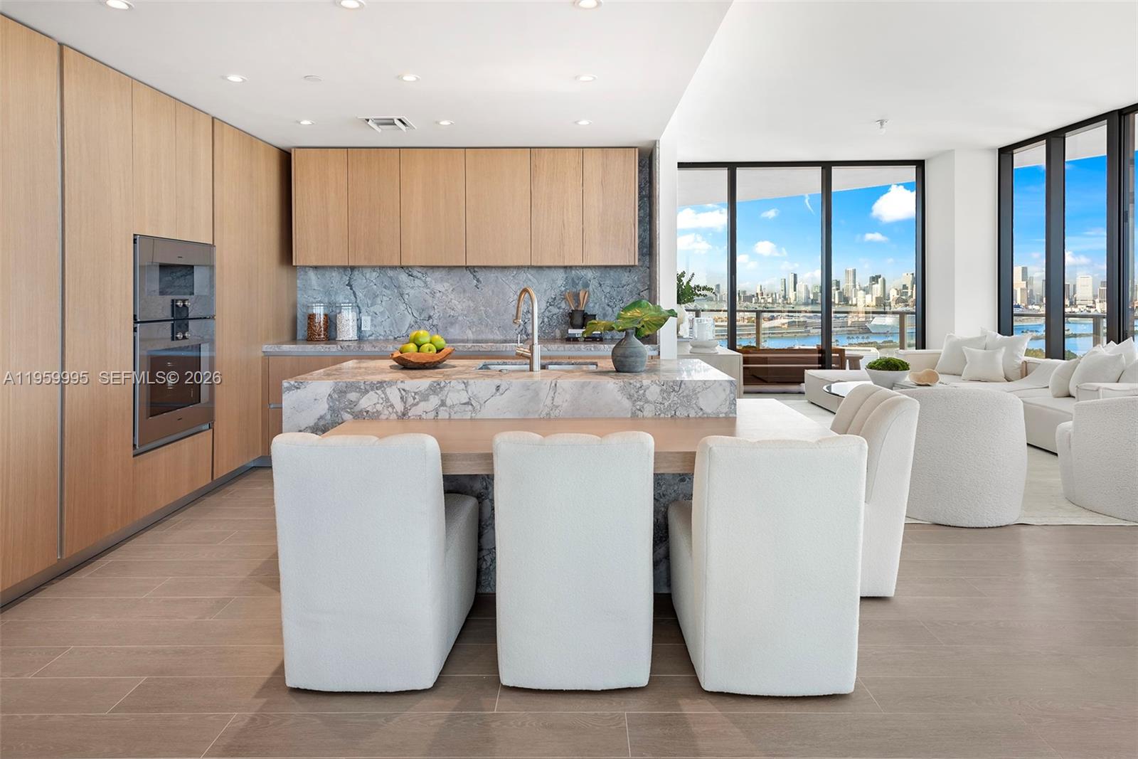 500 Alton Road, Unit 2903 Miami Beach, FL 33139 - Photo 4 of 52 a kitchen with kitchen island a large counter top space a sink a refrigerator and cabinets