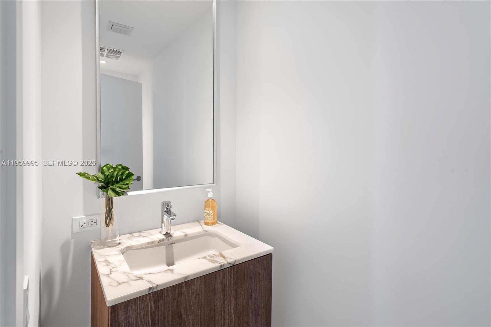 500 Alton Road, Unit 2903 Miami Beach, FL 33139 - Photo 42 of 52 a bathroom with a sink a vanity and a mirror