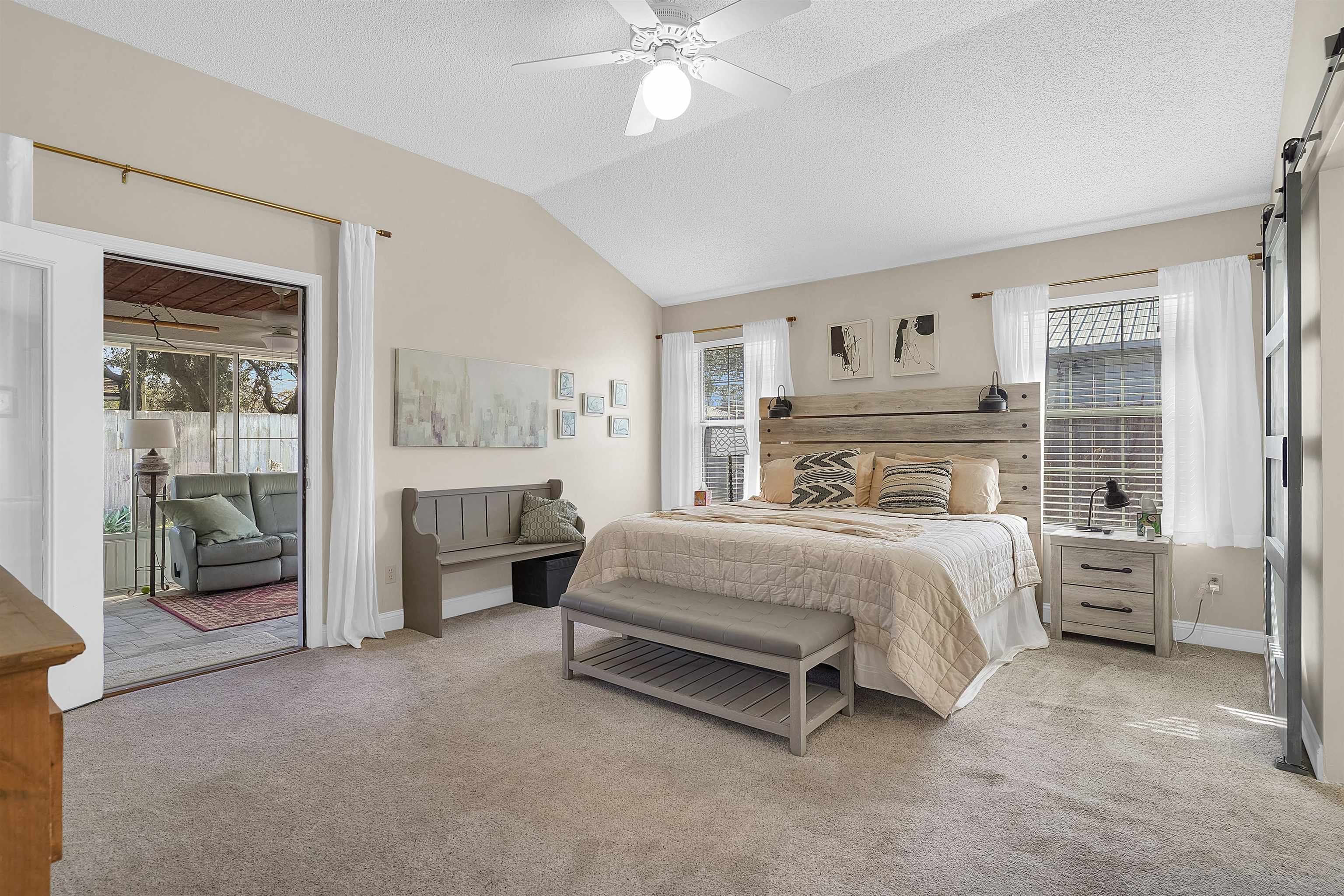 321 Mystical Way St. Augustine, FL 32080 - Photo 20 of 46 Bedroom with light colored carpet, multiple windows, and ceiling fan