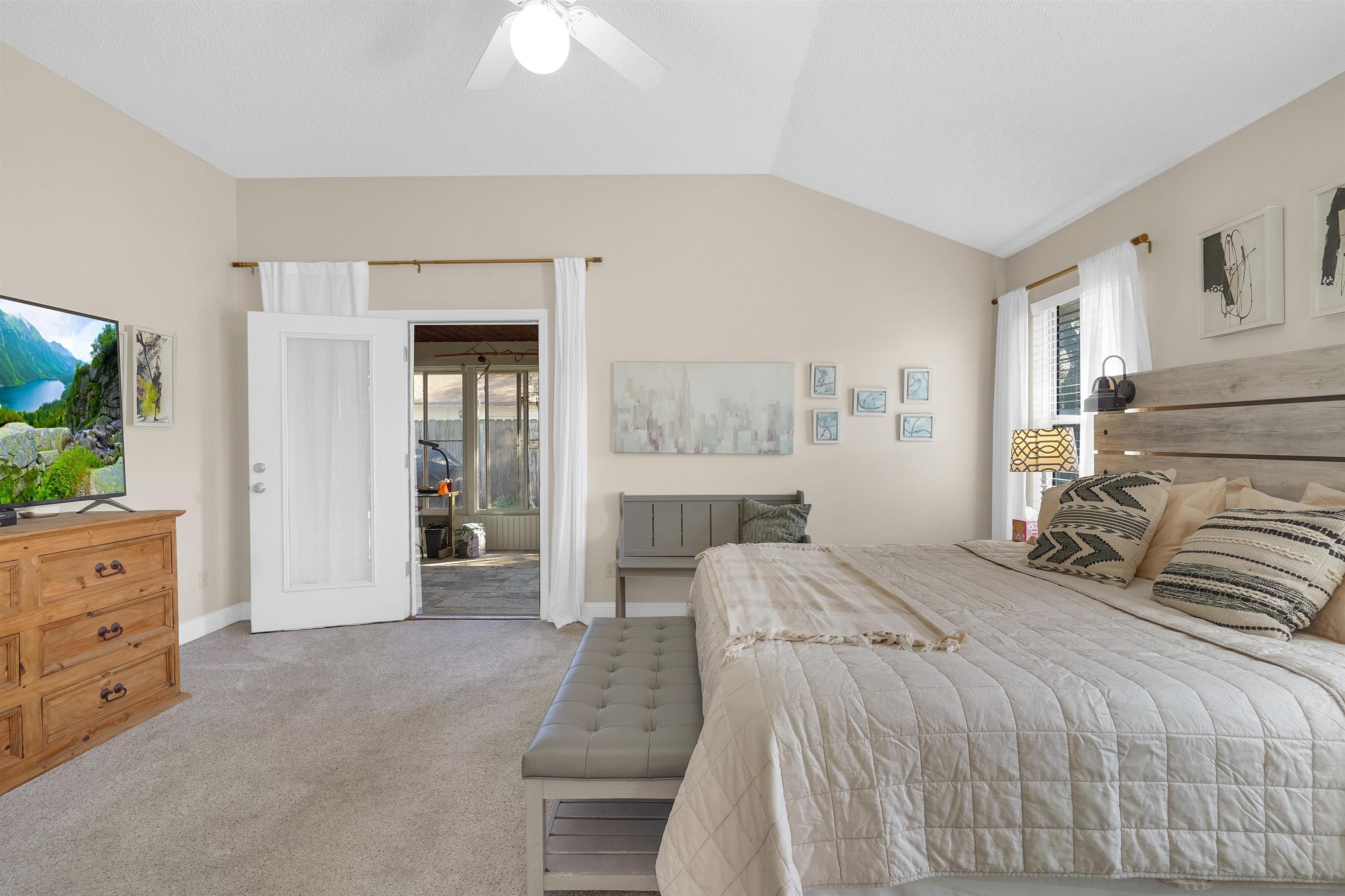 321 Mystical Way St. Augustine, FL 32080 - Photo 21 of 46 Bedroom with vaulted ceiling, light colored carpet, and a ceiling fan
