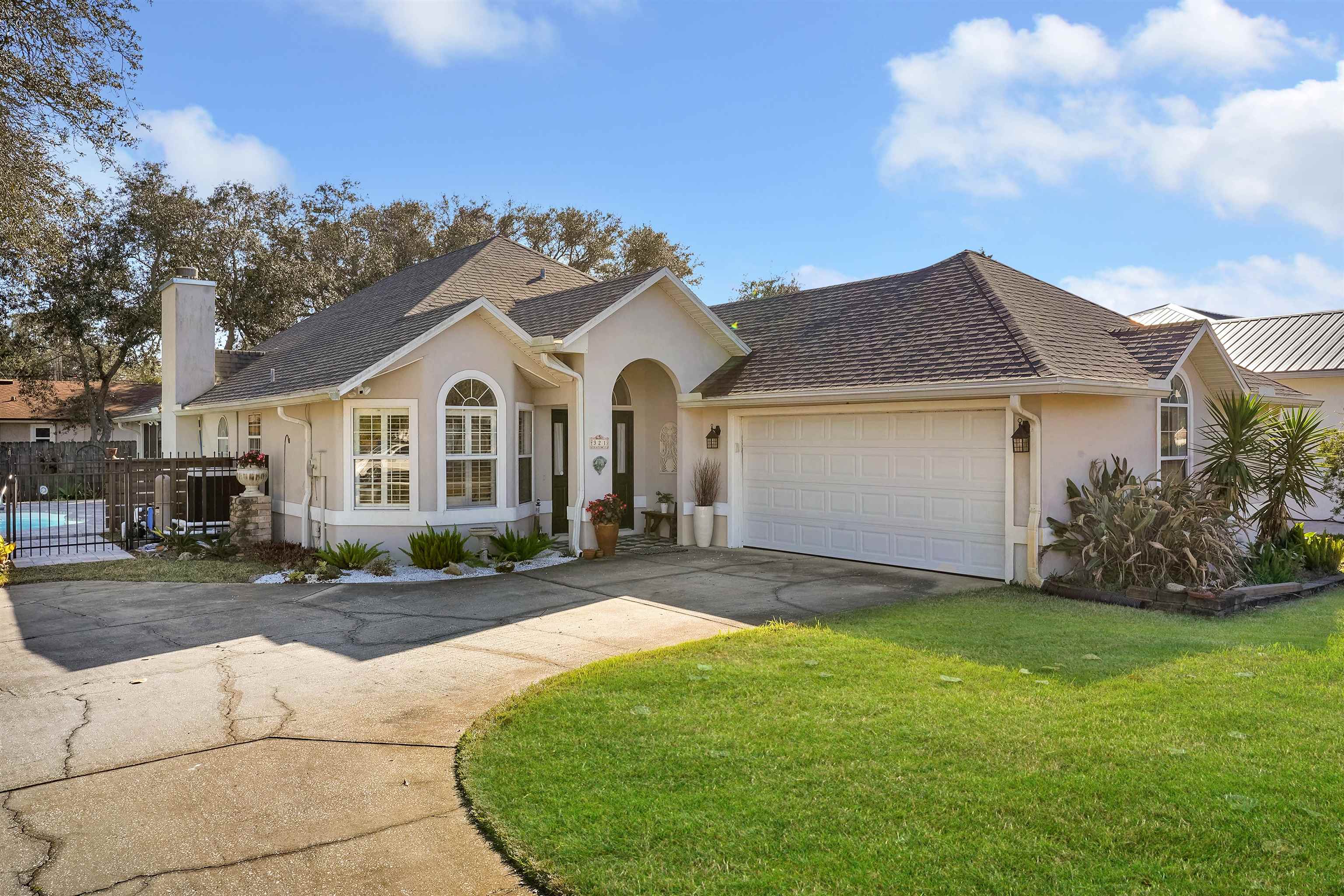 321 Mystical Way St. Augustine, FL 32080 - Photo 6 of 46 Single story home featuring stucco siding, an attached garage, driveway, a chimney, and a shingled roof