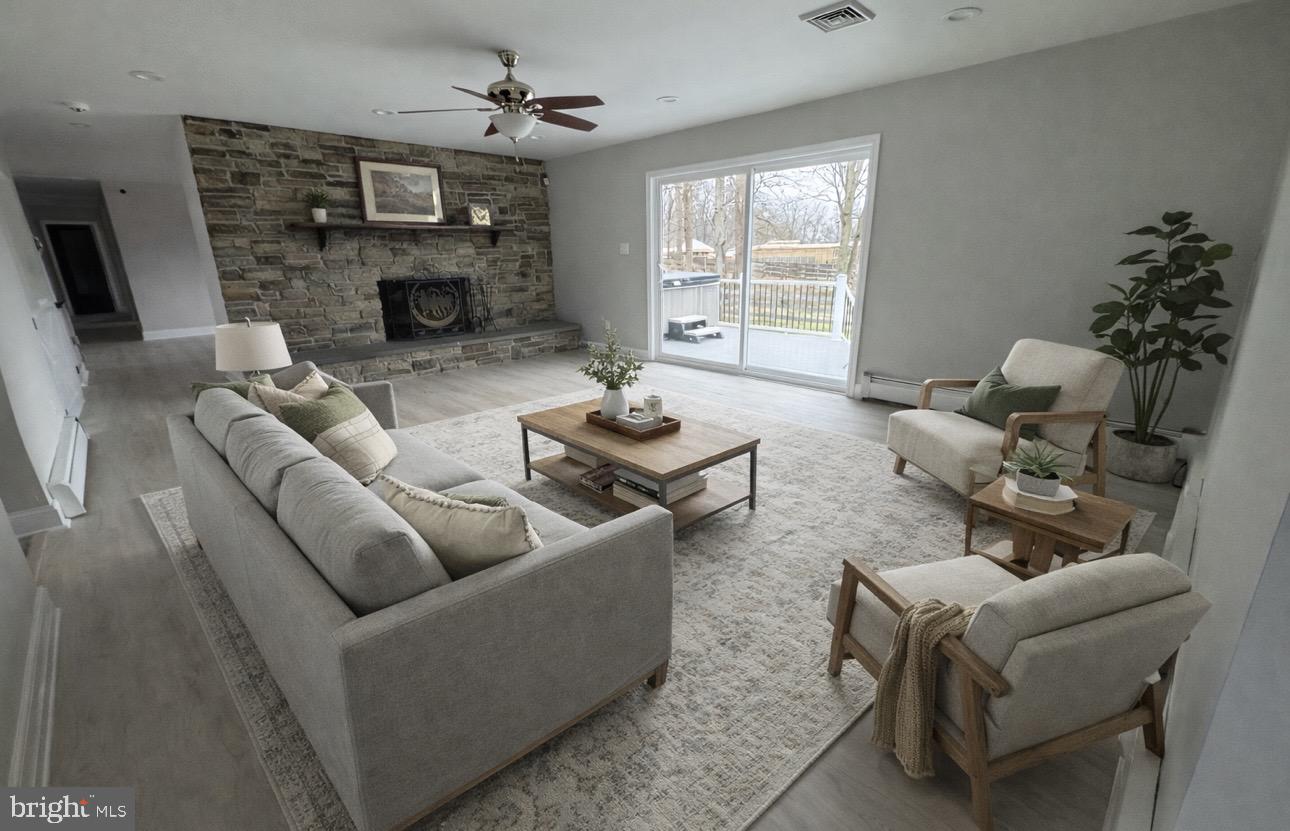26410 Haines Road Clarksburg, MD 20871 - Photo 13 of 33 a living room with furniture and a fireplace