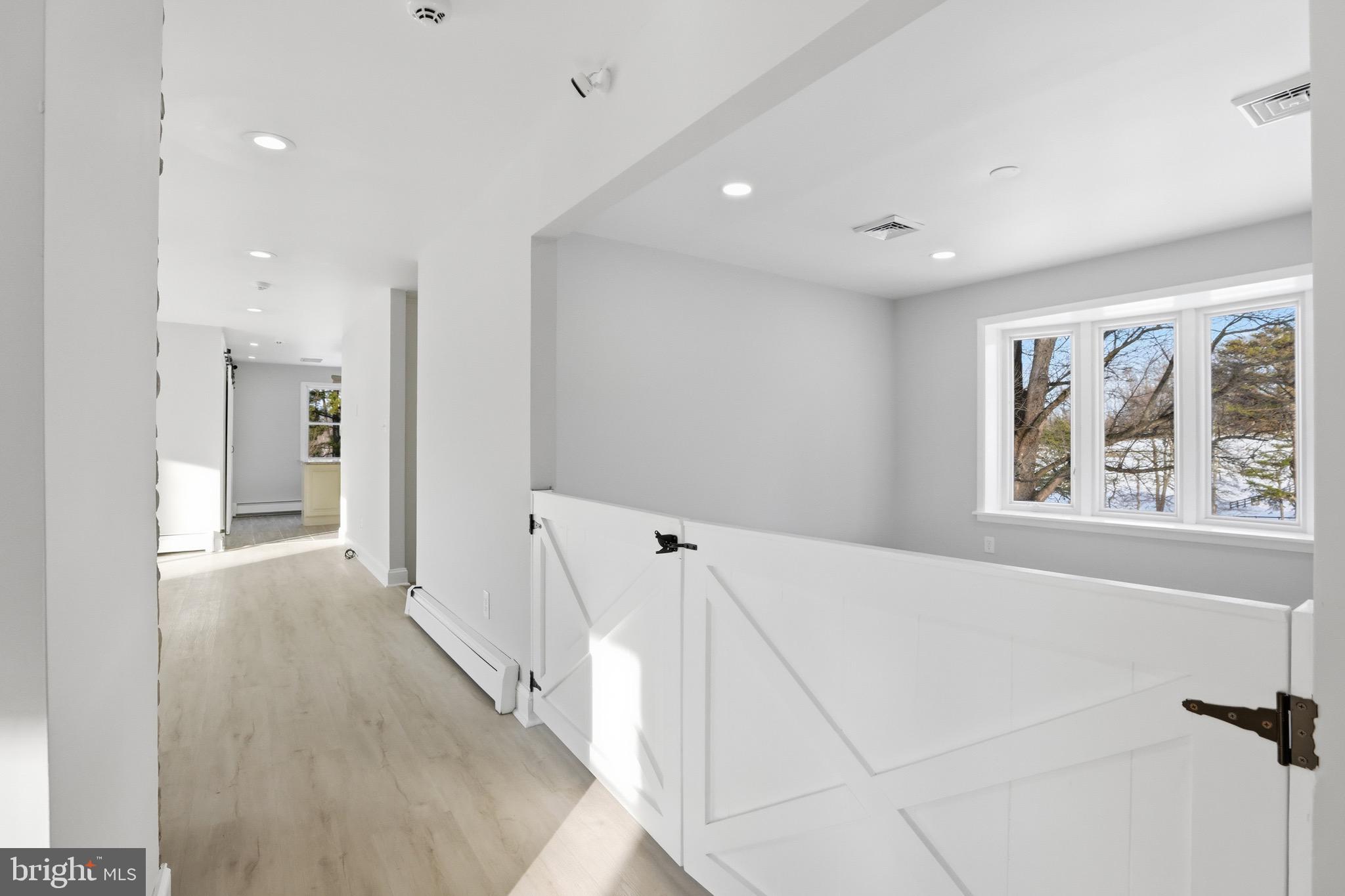 26410 Haines Road Clarksburg, MD 20871 - Photo 21 of 33 a view of a hallway with wooden floor