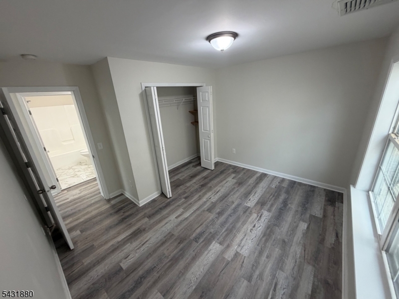 167 North 5th Street, Unit 2 Paterson, NJ 07522 - Photo 4 of 8 an empty room with wooden floor and entrance
