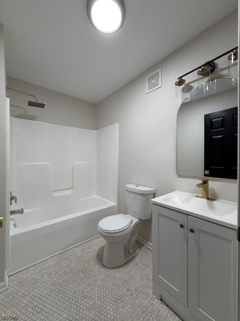 167 North 5th Street, Unit 2 Paterson, NJ 07522 - Photo 5 of 8 a bathroom with a toilet a sink and a bathtub