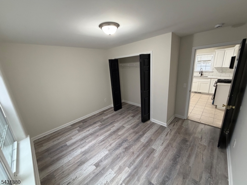 167 North 5th Street, Unit 2 Paterson, NJ 07522 - Photo 6 of 8 wooden floor in an empty room with a window