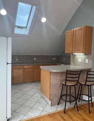 a kitchen with a sink a cabinets and chairs