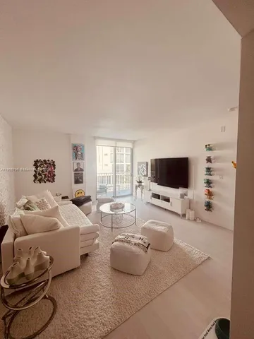 a bedroom with furniture and a flat screen tv