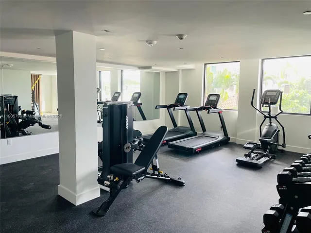 a room with gym equipment and a large window