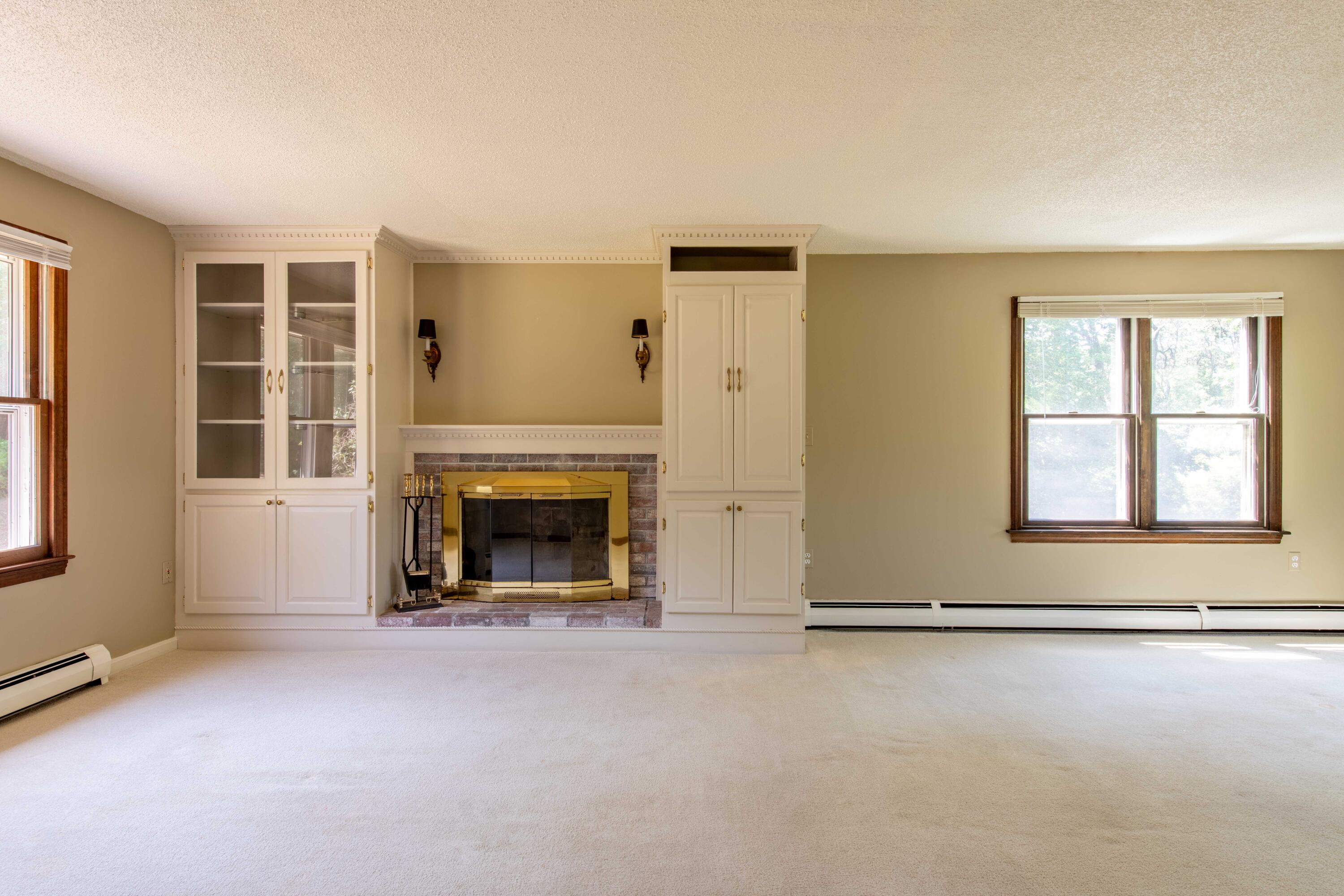 501 County Road Pocasset, MA 02559 - Photo 14 of 33 an empty room with windows and fireplace