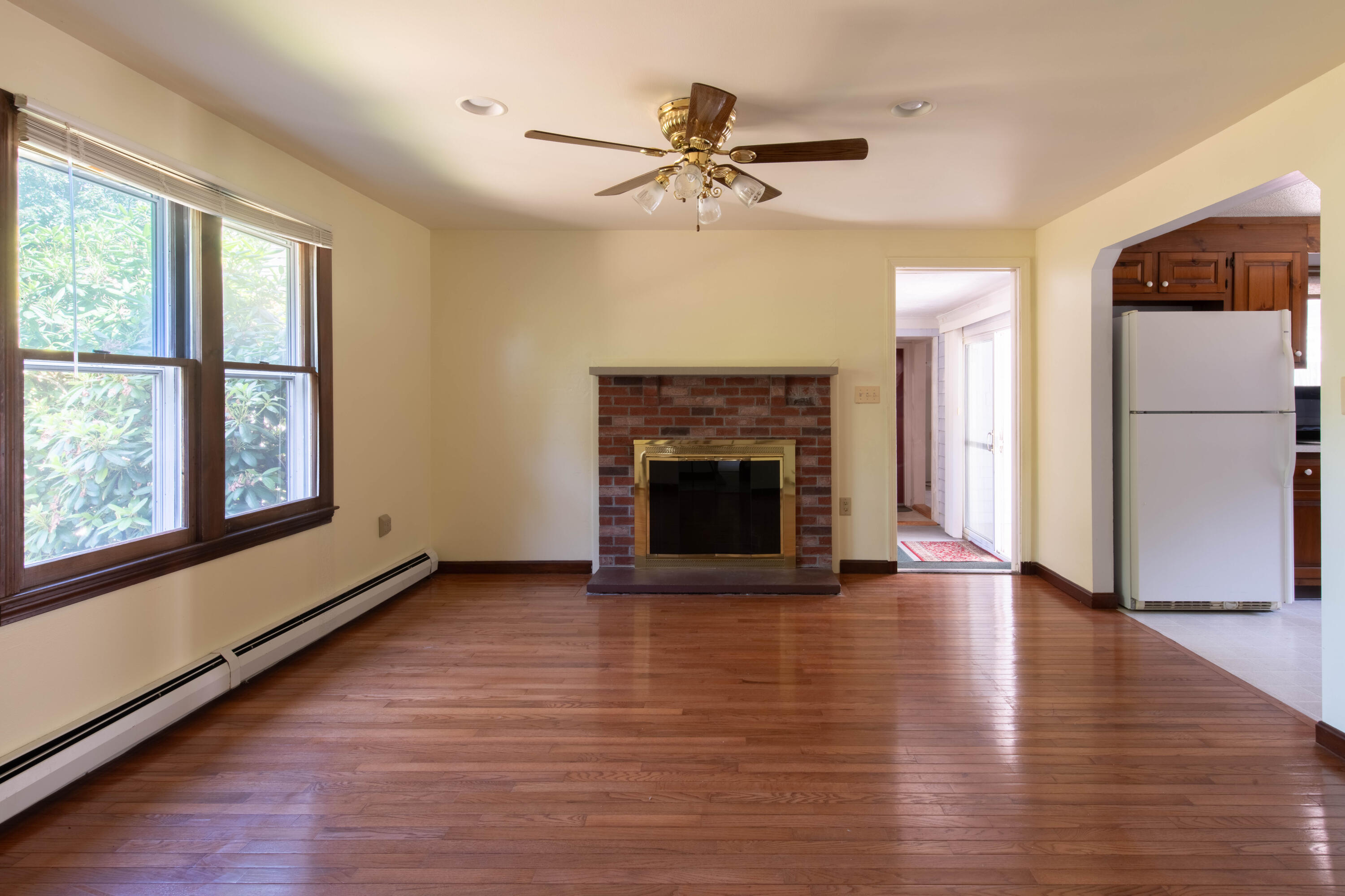 501 County Road Pocasset, MA 02559 - Photo 8 of 33 an empty room with windows and a fireplace
