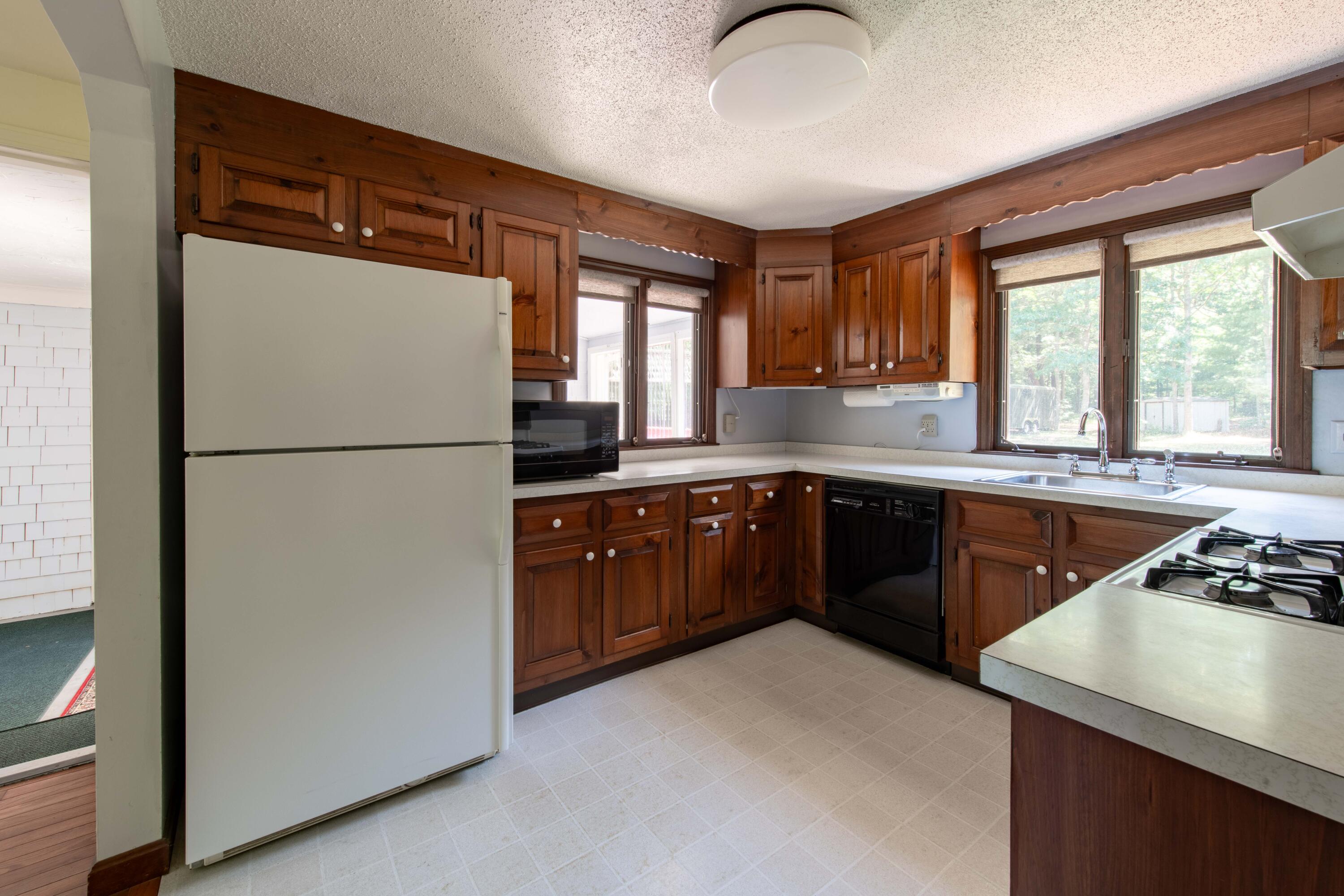 501 County Road Pocasset, MA 02559 - Photo 10 of 33 a kitchen with a refrigerator a sink and a stove