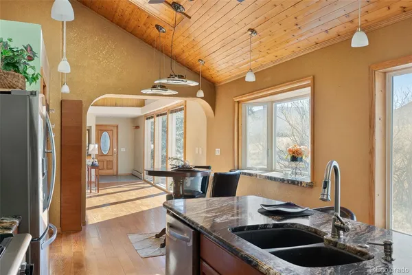 a kitchen with a sink and a stove next to a window