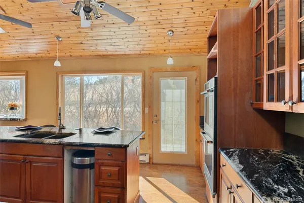 a kitchen with stainless steel appliances granite countertop a stove and a sink