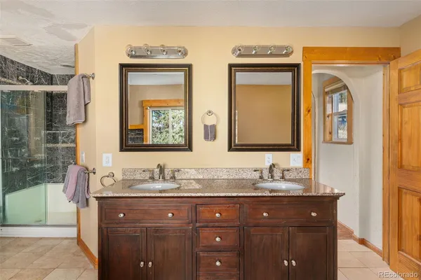 a bathroom with 2 sink and a mirror