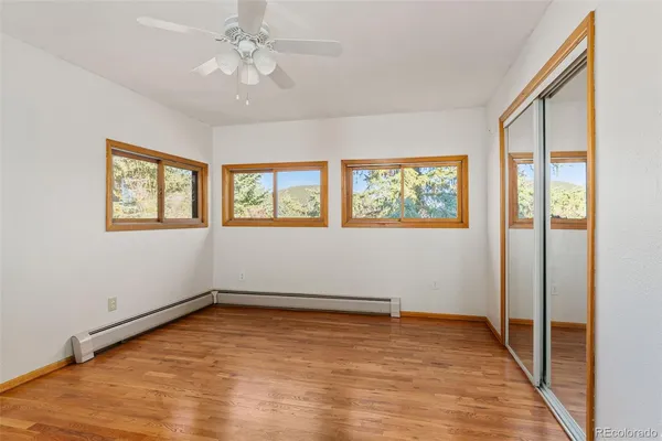 wooden floor in an empty room with a window