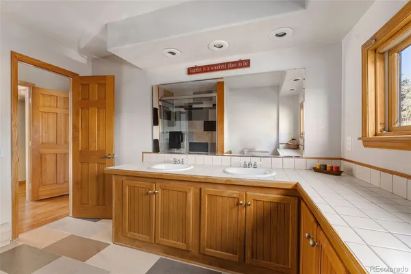 a spacious bathroom with a granite countertop sink and a mirror