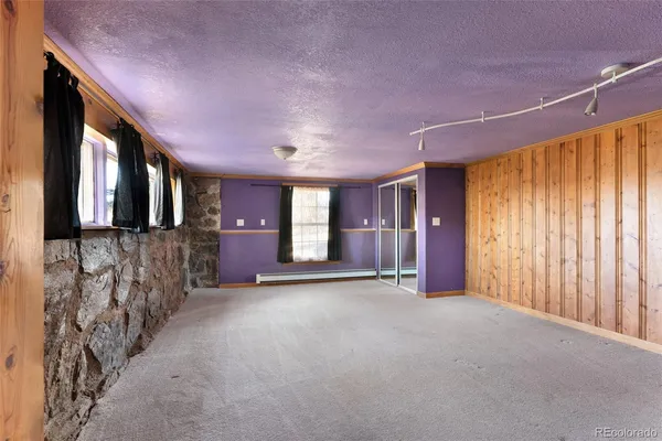 a house view with a sitting space fire pit and wooden fence
