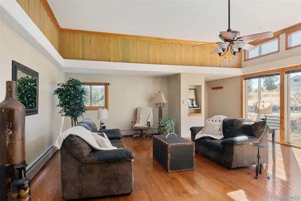 a living room with furniture or couch and a chandelier