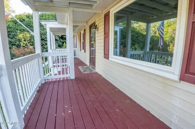 a view of porch with wooden floor