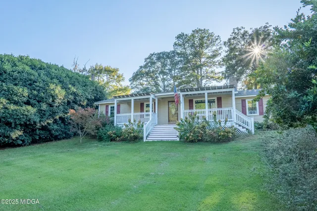 a front view of house with yard and green space