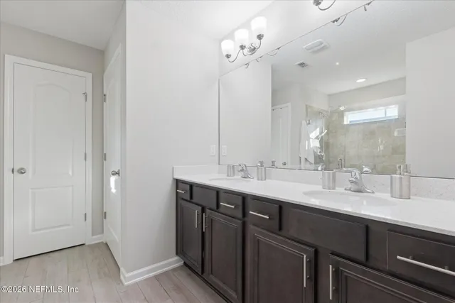 a bed room with a bed and a chandelier