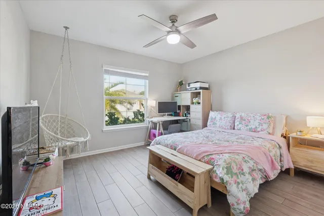 a living room with a bed furniture and a window