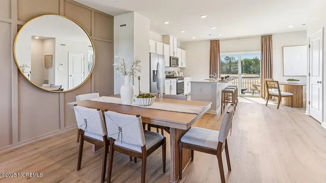 a dining room with furniture a window and wooden floor
