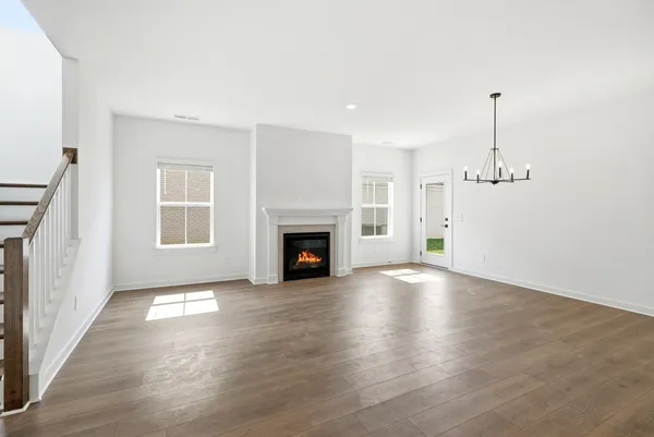 a view of a kitchen with wooden floor and a window
