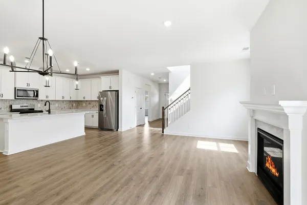 a view of empty room with wooden floor and fireplace