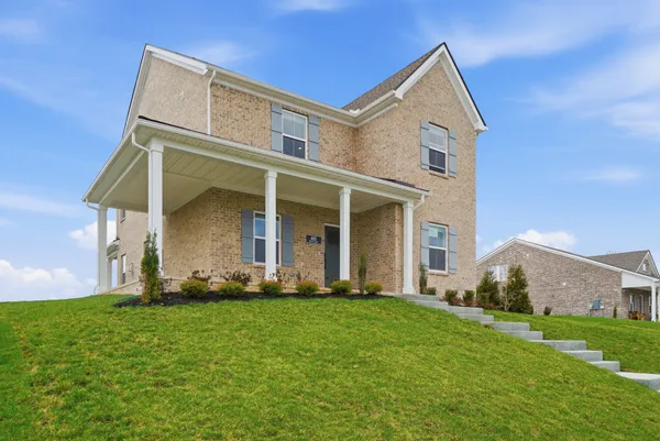 a front view of a house with a yard and garage