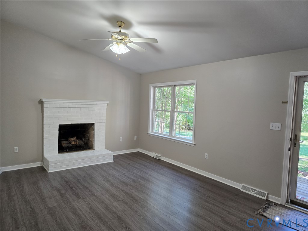 2578 Bagby Road Bumpass, VA 23024 - Photo 7 of 26 Vaulted ceiling with a ceiling fan, white brick fi