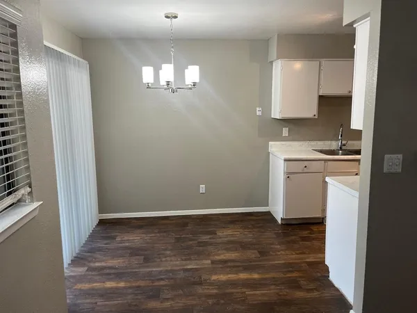 a view of a kitchen with a sink cabinets and wooden floor